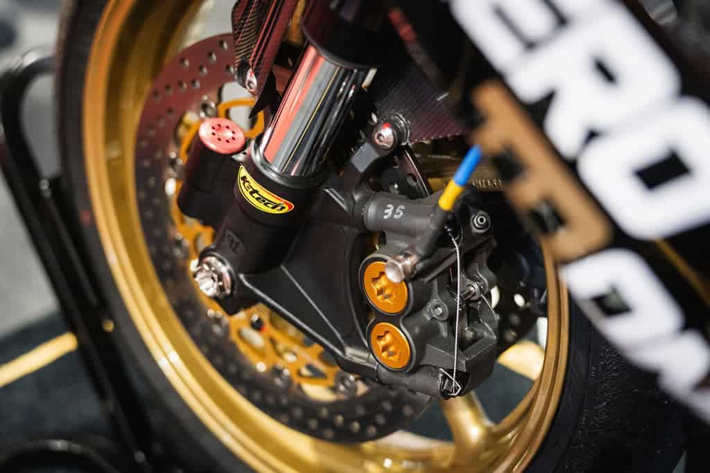 Close up of front brake calliper showing lockwired calliper bolts and brake pad pin lockwired to the calliper body