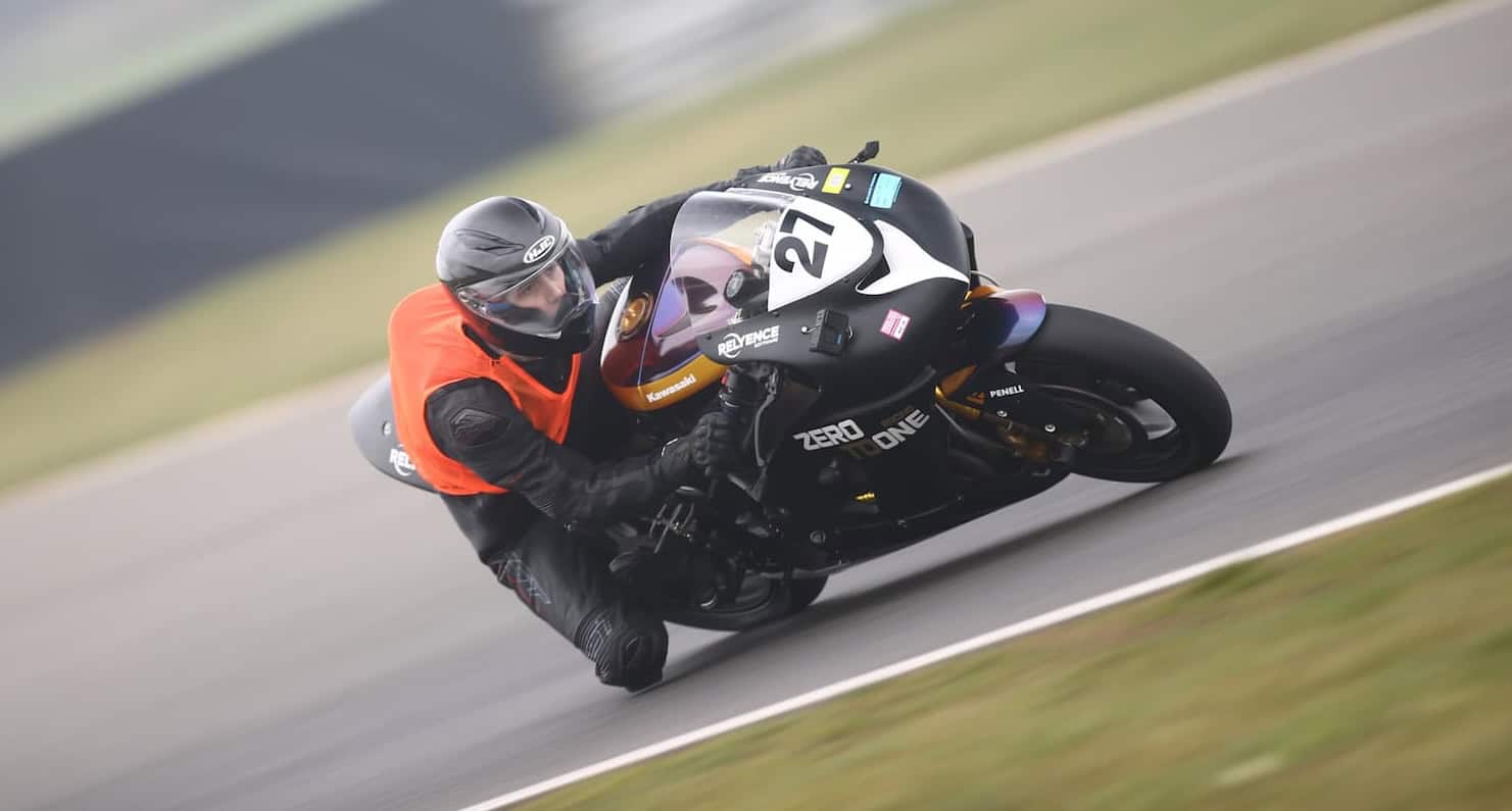 Evan #27 motorcycle racer mid corner knee down