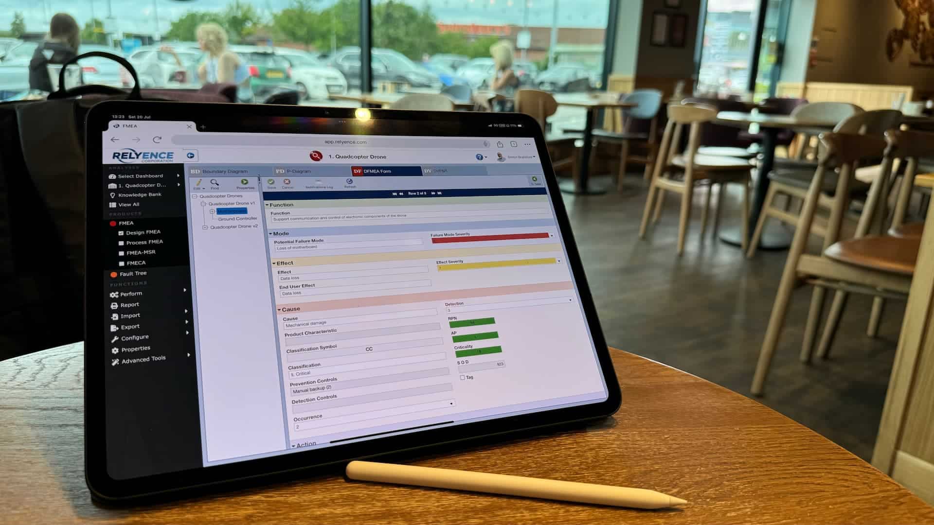 remote working on a design FMEA on an ipad located in a coffee shop