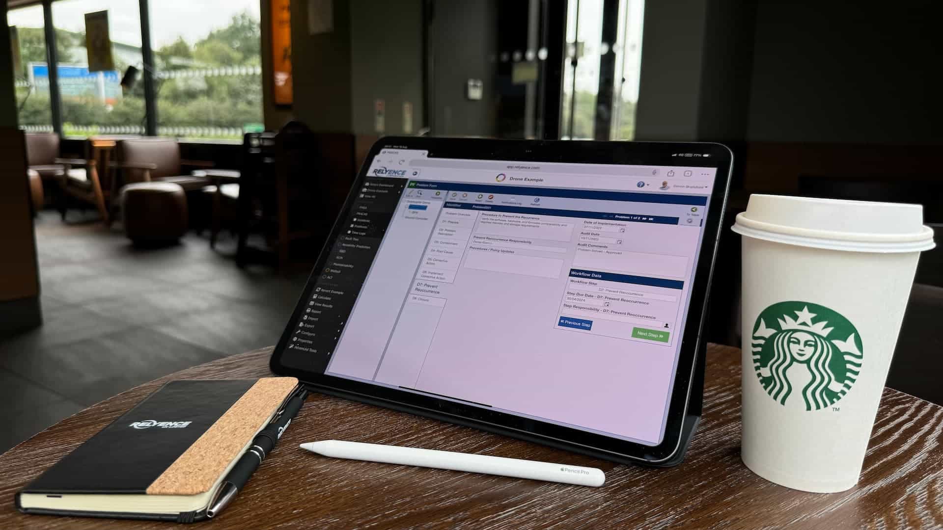 FRACAS - failure reporting analysis & corrective action system displaying 8D problem solving on an ipad pro in a coffee shop
