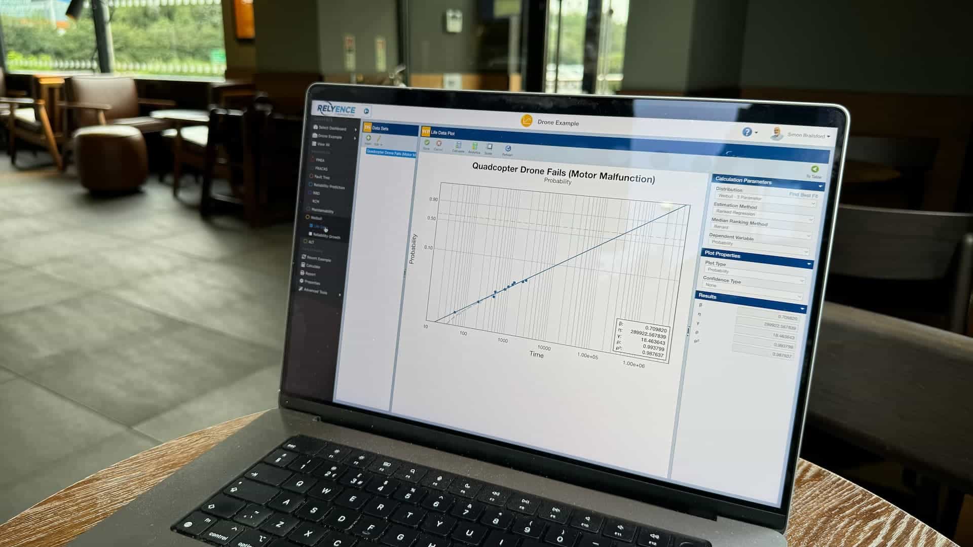 Weibull Life Data Analysis shown on a laptop working in a coffee shop